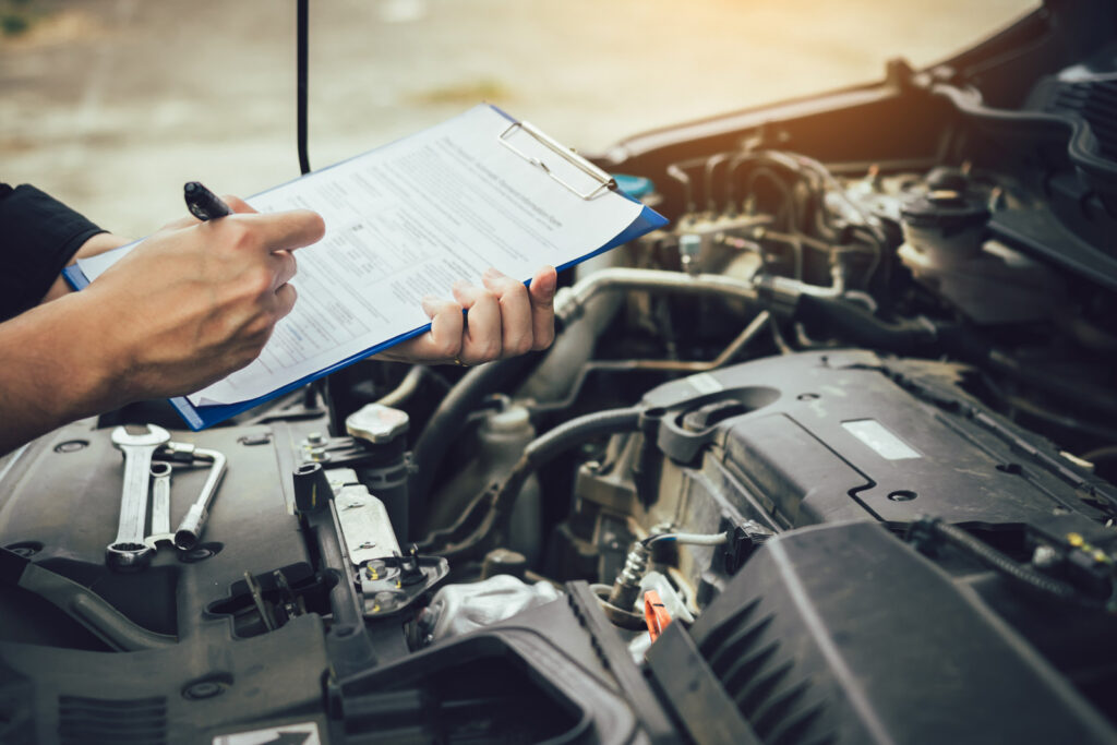 person inspecting car engine