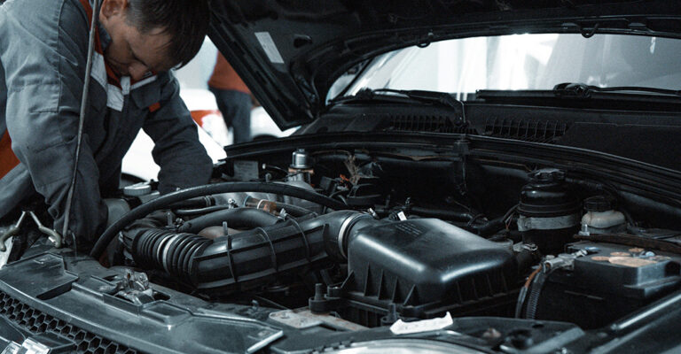 Mechanic checking car engine