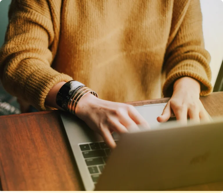 Person typing on laptop computer keypad.